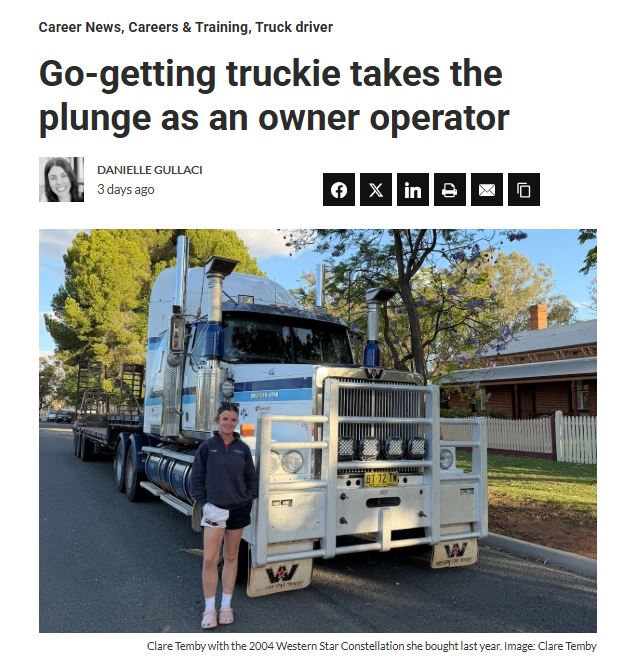 Woman standing next to a large truck as business owner